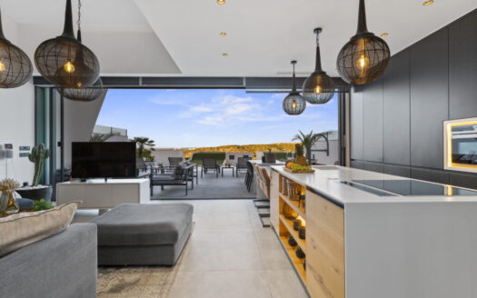 European couple overlooking the Mediterranean, considering an exclusive real estate sale in Costa Blanca
